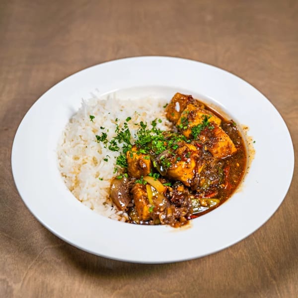 Z Cafe & Bar's American dish with rice and a rich, dark stew topped with fresh parsley.